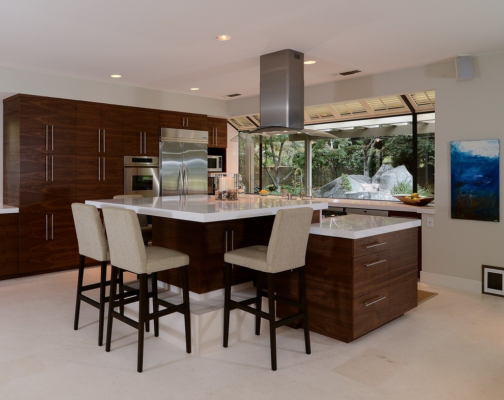 Inspiration for a modern l-shaped eat-in kitchen remodel in Sacramento with flat-panel cabinets, dark wood cabinets, stainless steel appliances and an island