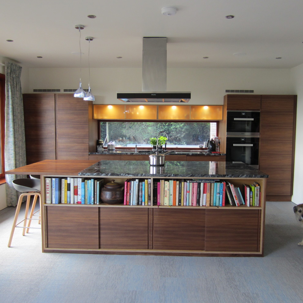 Design ideas for a contemporary single-wall open plan kitchen in Other with a built-in sink, flat-panel cabinets, dark wood cabinets, granite worktops, stainless steel appliances, vinyl flooring, an island, multi-coloured floors and multicoloured worktops.