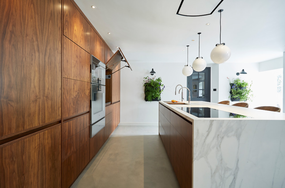 Medium sized contemporary single-wall kitchen in Devon with flat-panel cabinets, dark wood cabinets, marble worktops, integrated appliances, concrete flooring, a breakfast bar and grey floors.