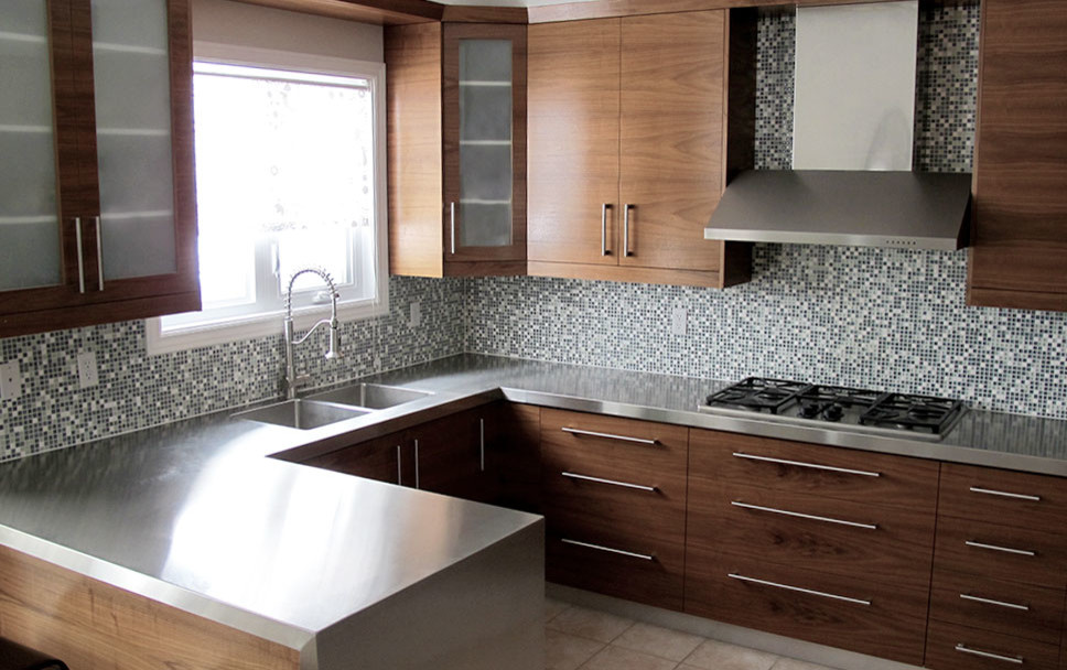 Example of a mid-sized minimalist u-shaped ceramic tile eat-in kitchen design in Toronto with an undermount sink, flat-panel cabinets, dark wood cabinets, stainless steel countertops, blue backsplash, mosaic tile backsplash, stainless steel appliances and a peninsula