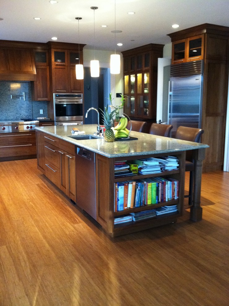Large trendy u-shaped medium tone wood floor eat-in kitchen photo in Philadelphia with an undermount sink, shaker cabinets, medium tone wood cabinets, granite countertops, green backsplash, stainless steel appliances and an island