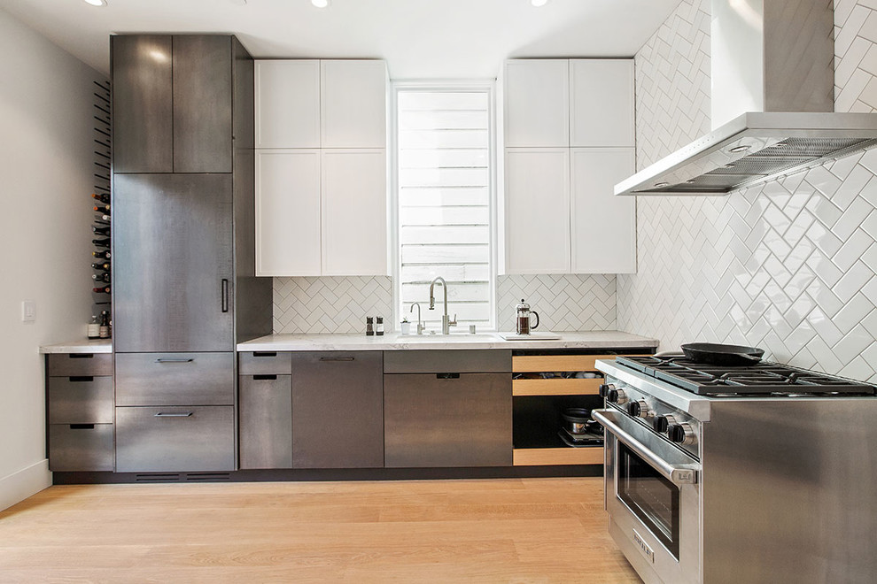 Enclosed kitchen - large modern l-shaped light wood floor enclosed kitchen idea in San Francisco with an undermount sink, recessed-panel cabinets, stainless steel cabinets, white backsplash, ceramic backsplash, stainless steel appliances, no island and quartzite countertops