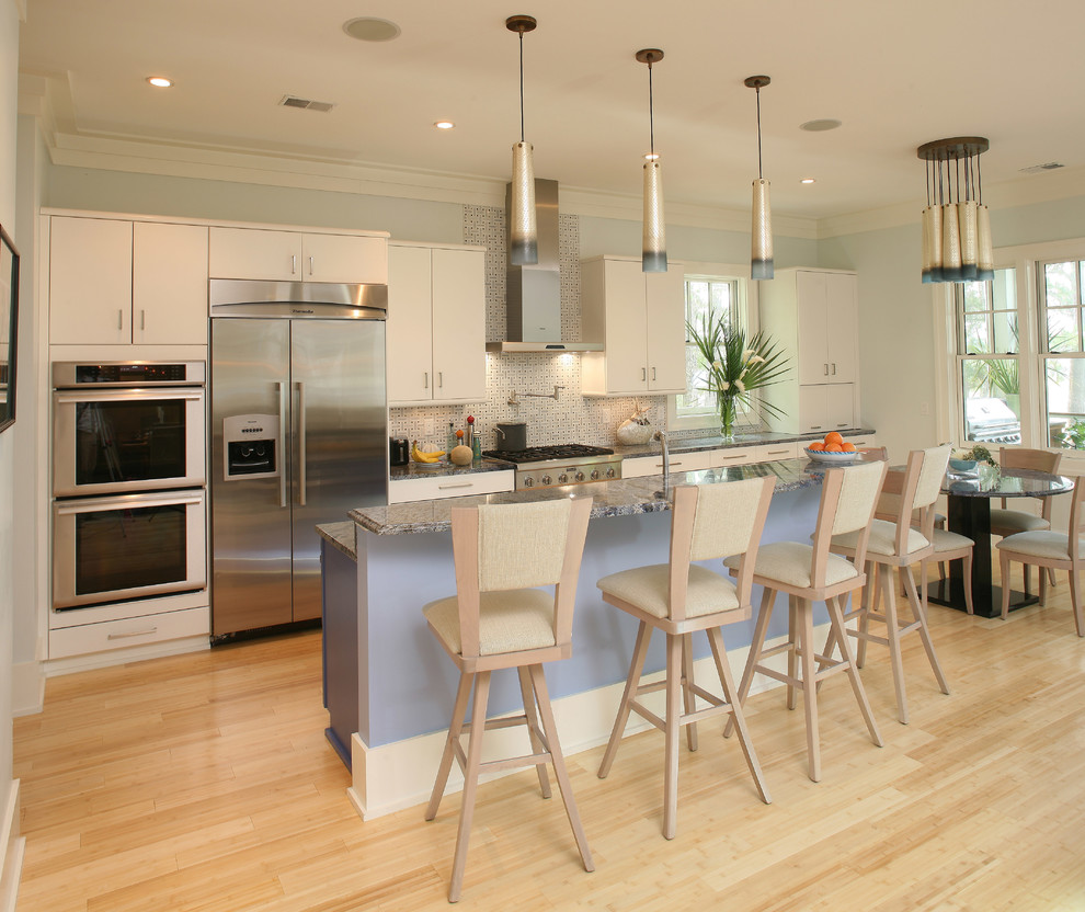 Inspiration for a transitional galley eat-in kitchen remodel in Charleston with flat-panel cabinets, white cabinets, stainless steel appliances and white backsplash
