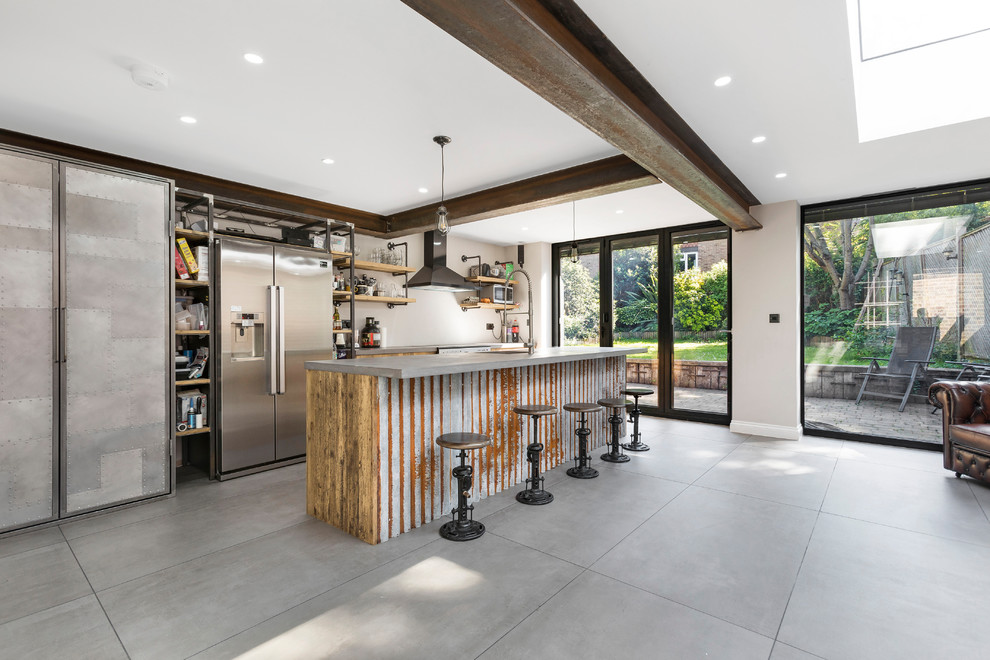 Inspiration for an industrial single-wall kitchen remodel in Other with stainless steel appliances and an island