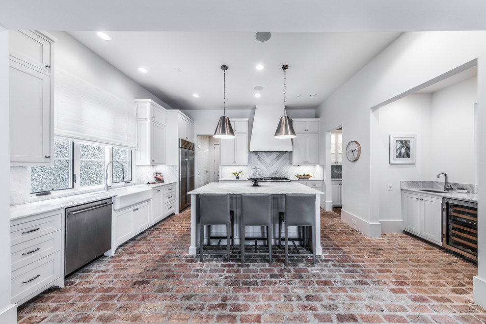 Inspiration for a large mediterranean u-shaped brick floor and white floor eat-in kitchen remodel in Houston with a double-bowl sink, raised-panel cabinets, white cabinets, marble countertops, white backsplash, marble backsplash, stainless steel appliances and an island