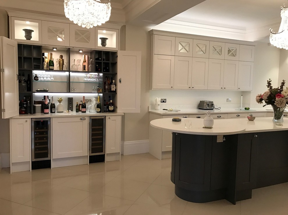 Photo of a large traditional kitchen/diner in Surrey with an integrated sink, shaker cabinets, white cabinets, quartz worktops, mosaic tiled splashback, stainless steel appliances and an island.