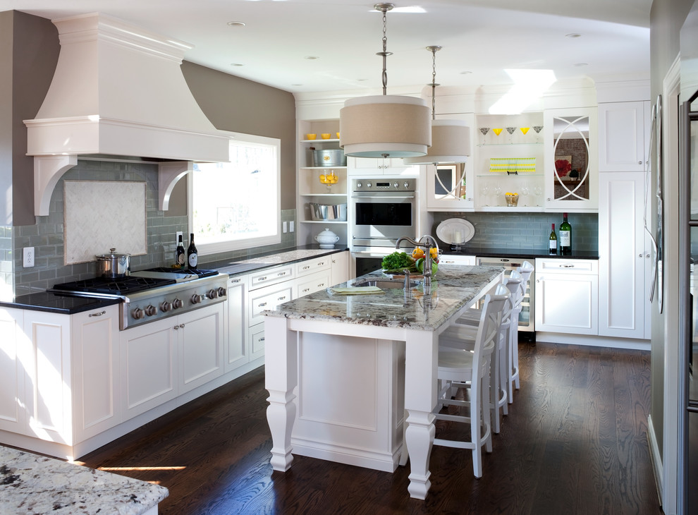 Eat-in kitchen - large traditional l-shaped dark wood floor eat-in kitchen idea in DC Metro with a single-bowl sink, recessed-panel cabinets, white cabinets, granite countertops, gray backsplash, subway tile backsplash, stainless steel appliances and two islands