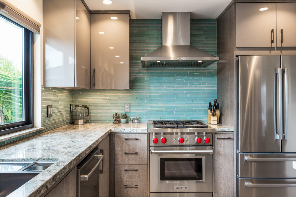 Mid-sized trendy bamboo floor eat-in kitchen photo in Other with a single-bowl sink, flat-panel cabinets, quartz countertops, green backsplash, glass tile backsplash, stainless steel appliances, an island and turquoise countertops