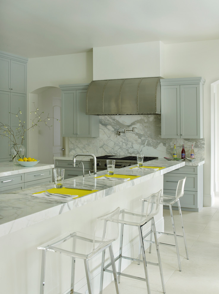 Eat-in kitchen - large traditional u-shaped ceramic tile eat-in kitchen idea in Houston with recessed-panel cabinets, blue cabinets, marble countertops, multicolored backsplash, stainless steel appliances and an island