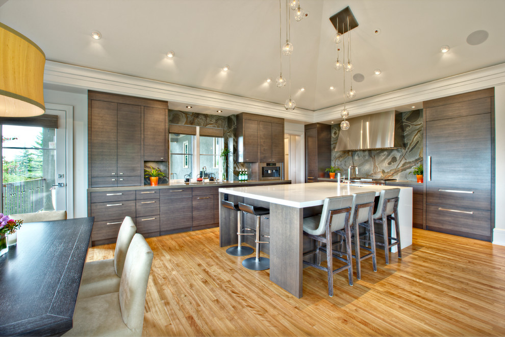 Inspiration for a contemporary l-shaped kitchen/diner in Calgary with flat-panel cabinets and dark wood cabinets.