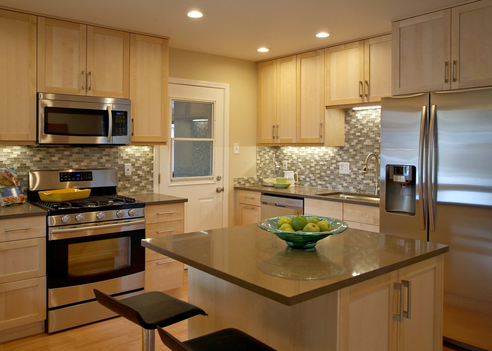 Example of a mid-sized transitional l-shaped light wood floor eat-in kitchen design in Omaha with an undermount sink, recessed-panel cabinets, medium tone wood cabinets, quartz countertops, multicolored backsplash and white appliances