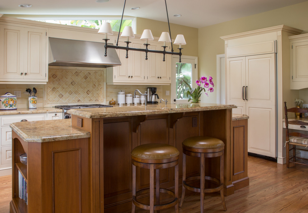 Photo of a traditional galley kitchen/diner in San Diego with an integrated sink, raised-panel cabinets, white cabinets, granite worktops, beige splashback, ceramic splashback and stainless steel appliances.