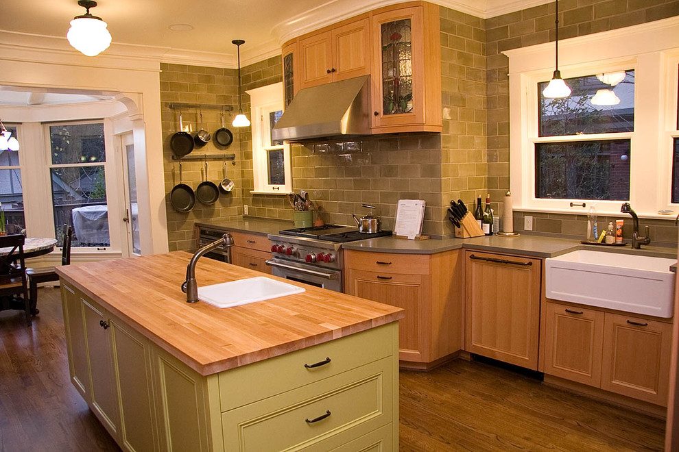 Moderne Wohnküche mit Küchengeräten aus Edelstahl, Einbauwaschbecken, Arbeitsplatte aus Holz, Schrankfronten mit vertiefter Füllung, grünen Schränken, Küchenrückwand in Grün und Rückwand aus Metrofliesen in Seattle