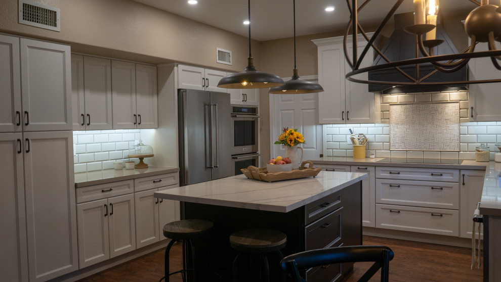 Inspiration for a mid-sized cottage u-shaped vinyl floor and brown floor open concept kitchen remodel in Phoenix with a single-bowl sink, flat-panel cabinets, white cabinets, quartz countertops, white backsplash, porcelain backsplash, stainless steel appliances, an island and beige countertops