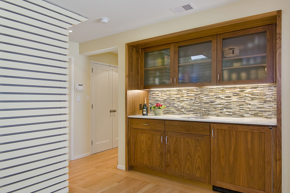 Trendy kitchen photo in San Francisco with glass-front cabinets, medium tone wood cabinets and multicolored backsplash