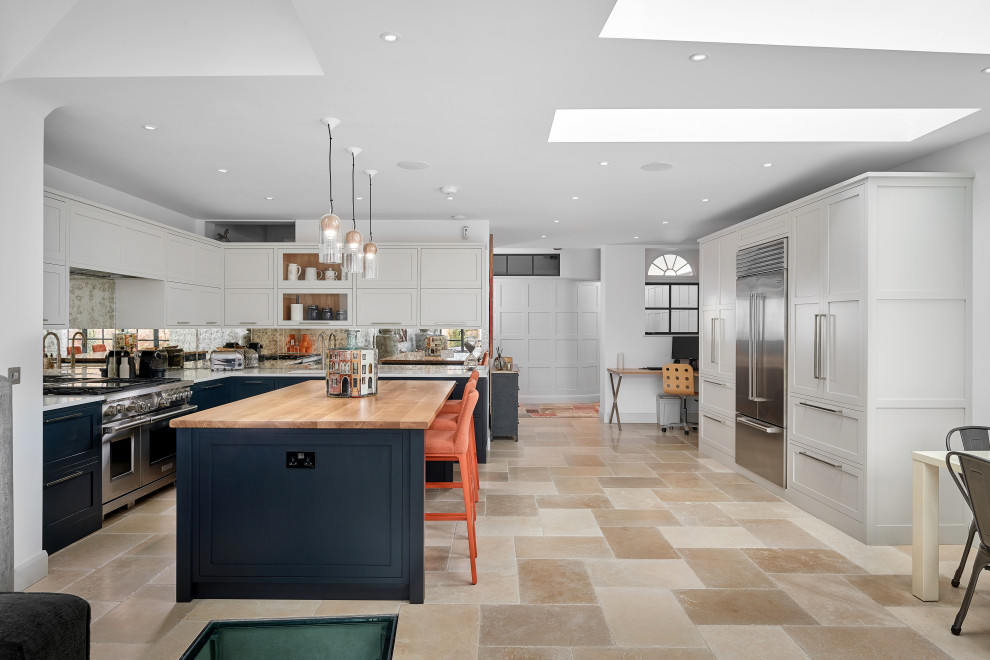 Inspiration for an expansive traditional single-wall kitchen in West Midlands with a double-bowl sink, shaker cabinets, grey cabinets, stainless steel appliances, an island, wood worktops, mirror splashback, beige floors and blue worktops.