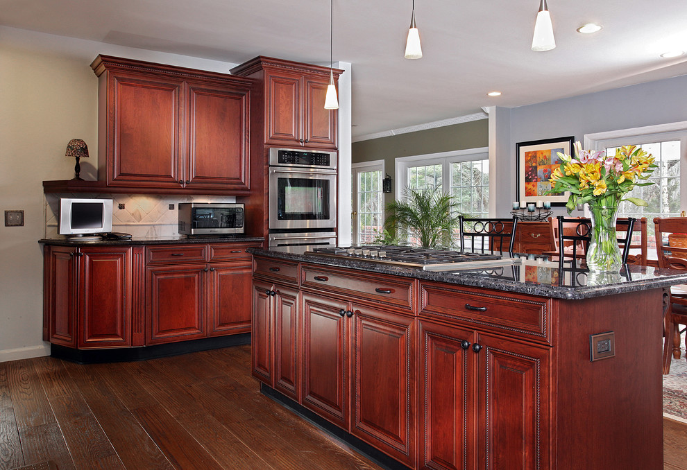 Example of a large tuscan u-shaped medium tone wood floor eat-in kitchen design in Philadelphia with a single-bowl sink, beaded inset cabinets, dark wood cabinets, quartzite countertops, ceramic backsplash, stainless steel appliances and an island