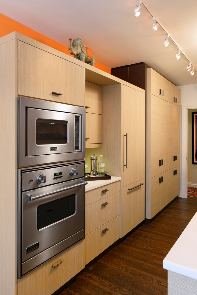 Small trendy galley dark wood floor eat-in kitchen photo in DC Metro with flat-panel cabinets, no island, an undermount sink, light wood cabinets, quartzite countertops, orange backsplash, stainless steel appliances and glass sheet backsplash