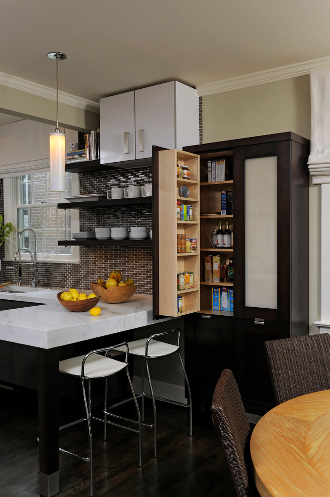 Mid-sized trendy u-shaped medium tone wood floor eat-in kitchen photo in DC Metro with an undermount sink, flat-panel cabinets, black cabinets, granite countertops, multicolored backsplash, glass tile backsplash, stainless steel appliances and a peninsula