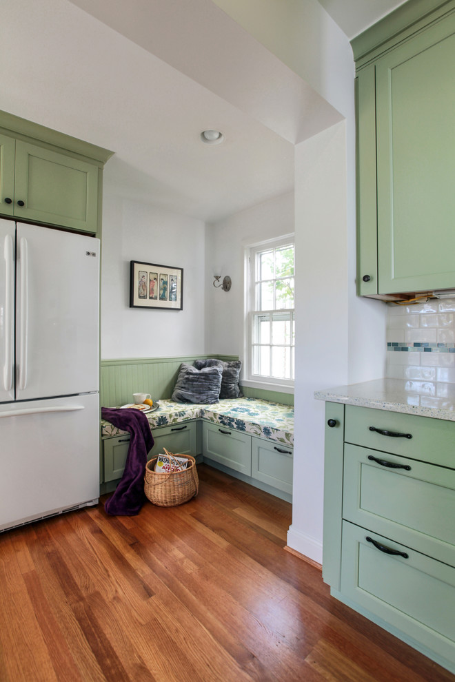 Inspiration for a small timeless galley medium tone wood floor enclosed kitchen remodel in DC Metro with a farmhouse sink, recessed-panel cabinets, green cabinets, quartz countertops, white backsplash, ceramic backsplash, white appliances and no island