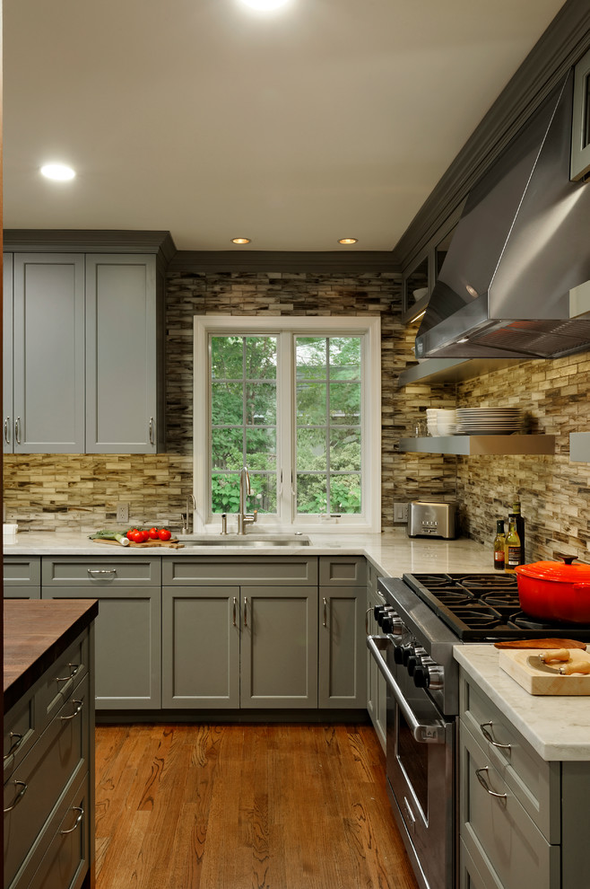 Mid-sized transitional l-shaped medium tone wood floor eat-in kitchen photo in DC Metro with an undermount sink, shaker cabinets, gray cabinets, quartz countertops, multicolored backsplash, glass tile backsplash, paneled appliances and an island