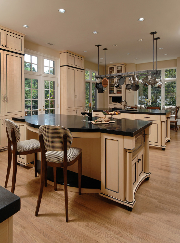 Inspiration for a large asian l-shaped light wood floor and beige floor eat-in kitchen remodel in DC Metro with an undermount sink, recessed-panel cabinets, beige cabinets, solid surface countertops, metallic backsplash, metal backsplash, stainless steel appliances and two islands