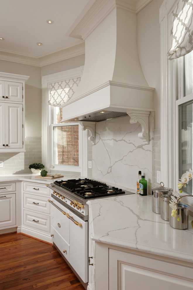 Inspiration for a medium sized victorian u-shaped kitchen/diner in DC Metro with a submerged sink, beaded cabinets, white cabinets, granite worktops, white splashback, stone slab splashback, integrated appliances, dark hardwood flooring and an island.