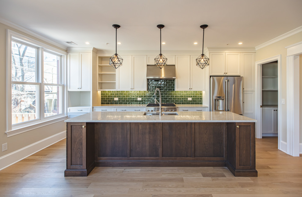 This is an example of a medium sized u-shaped open plan kitchen in DC Metro with a submerged sink, recessed-panel cabinets, white cabinets, marble worktops, green splashback, metro tiled splashback, stainless steel appliances, light hardwood flooring, an island, brown floors and grey worktops.