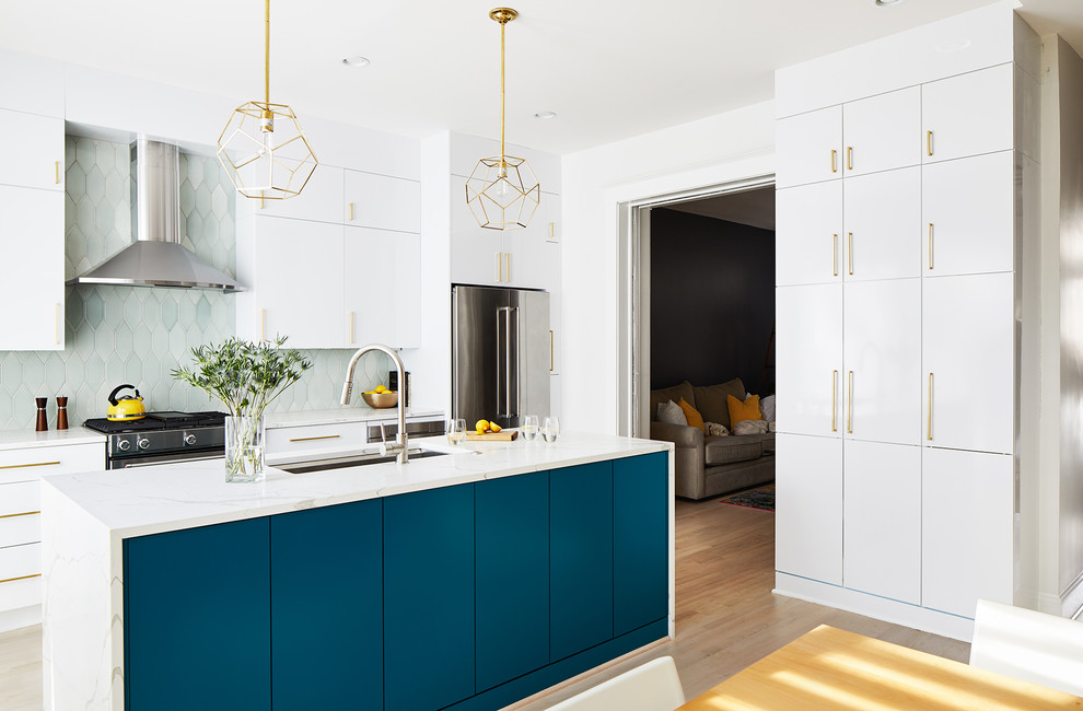 Trendy light wood floor kitchen photo in DC Metro with flat-panel cabinets, turquoise cabinets, green backsplash, stainless steel appliances, an island and white countertops