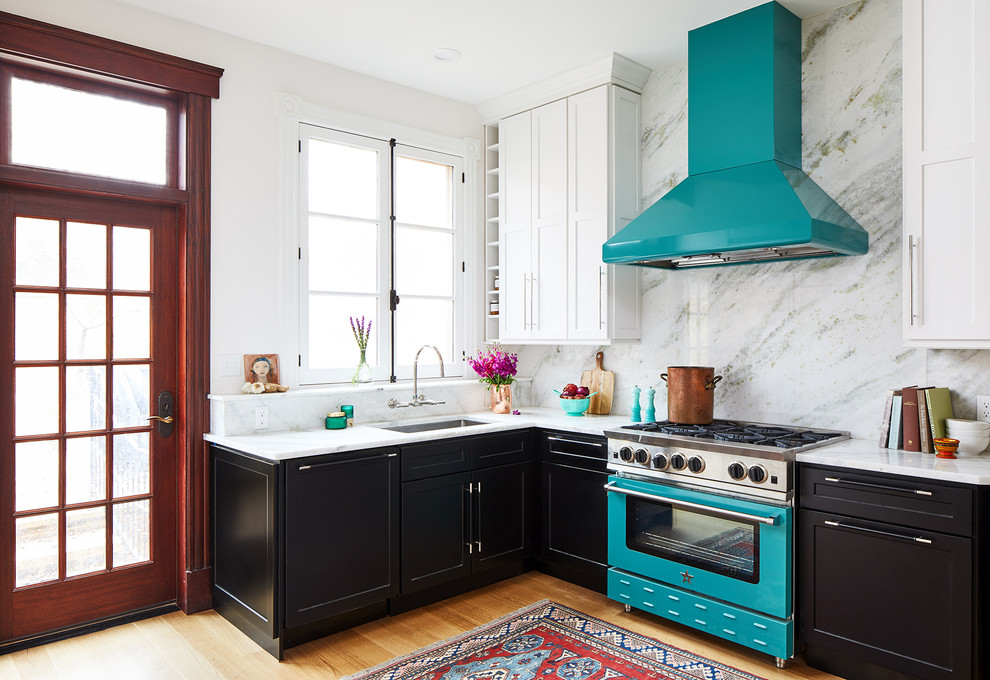 Mid-sized transitional l-shaped medium tone wood floor and brown floor kitchen photo in DC Metro with black cabinets, white backsplash, colored appliances, white countertops and an undermount sink