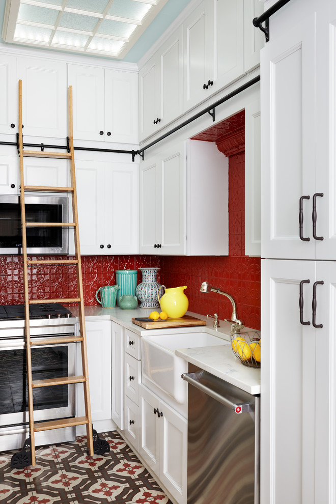 Inspiration for a small transitional galley multicolored floor kitchen remodel in DC Metro with a farmhouse sink, shaker cabinets, white cabinets, marble countertops, red backsplash, stainless steel appliances and no island