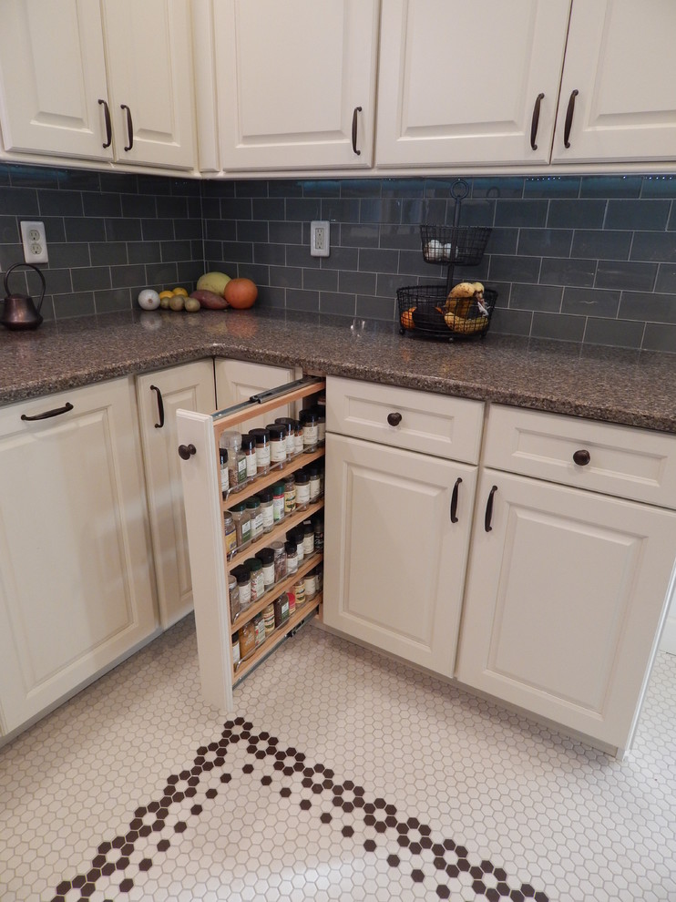 Medium sized classic u-shaped kitchen/diner in Denver with a belfast sink, raised-panel cabinets, white cabinets, engineered stone countertops, green splashback, glass tiled splashback, stainless steel appliances, ceramic flooring and no island.