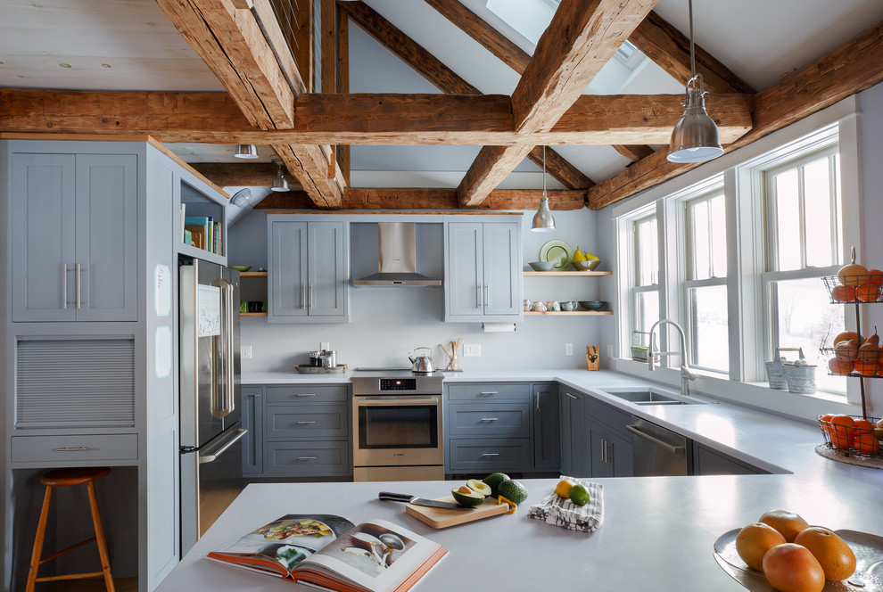 Farmhouse u-shaped enclosed kitchen in Burlington with shaker cabinets, a double-bowl sink, grey cabinets, grey splashback, stainless steel appliances and a breakfast bar.