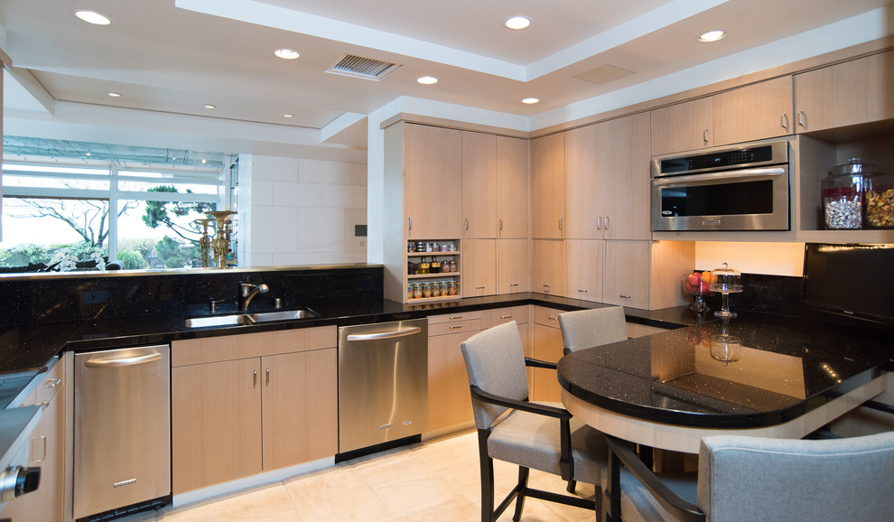Photo of a large contemporary u-shaped enclosed kitchen in Seattle with a double-bowl sink, flat-panel cabinets, medium wood cabinets, marble worktops, black splashback, stone slab splashback, stainless steel appliances, porcelain flooring and a breakfast bar.