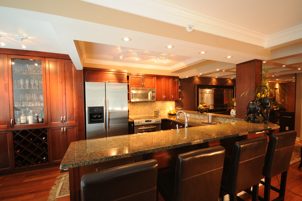 Bild på ett mellanstort vintage kök, med en undermonterad diskho, skåp i shakerstil, skåp i mellenmörkt trä, granitbänkskiva, flerfärgad stänkskydd, stänkskydd i mosaik, rostfria vitvaror, mellanmörkt trägolv, en halv köksö och brunt golv
