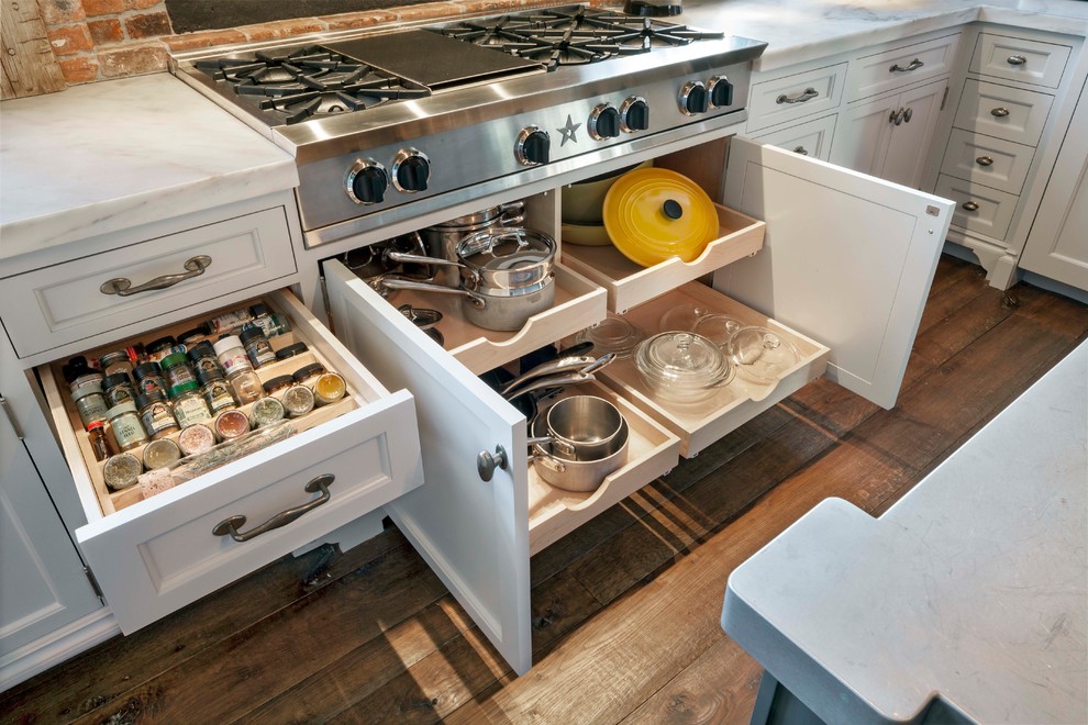 Eat-in kitchen - large eclectic u-shaped medium tone wood floor and brown floor eat-in kitchen idea in Other with glass-front cabinets, an island, white cabinets, granite countertops and brown backsplash