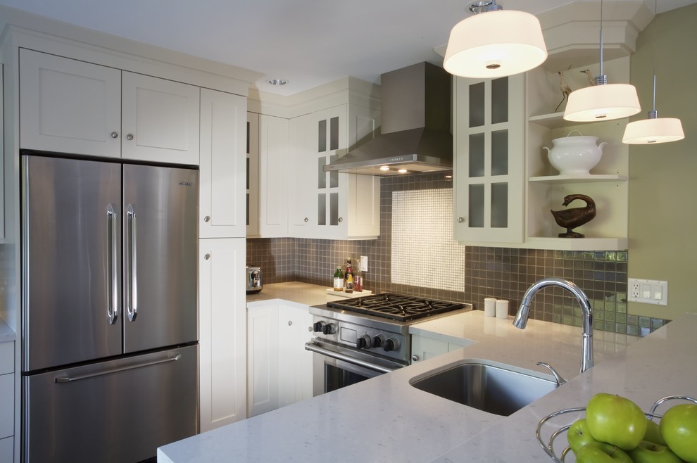 Kitchen - traditional kitchen idea in Vancouver with a farmhouse sink, shaker cabinets, white cabinets, quartz countertops, porcelain backsplash and stainless steel appliances
