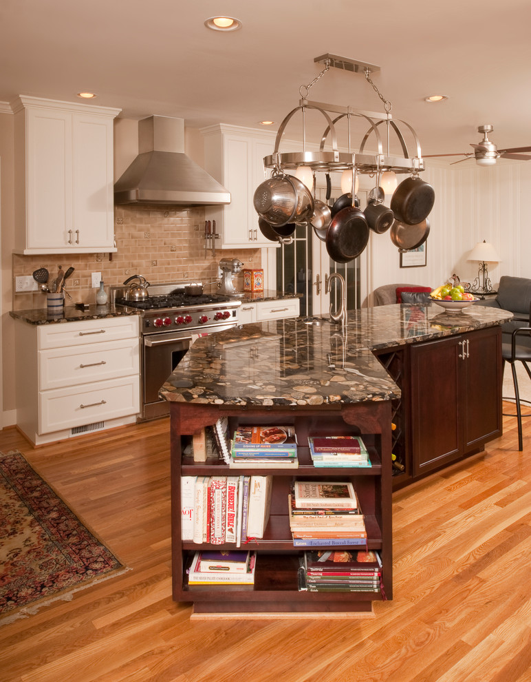 Eat-in kitchen - large traditional u-shaped medium tone wood floor eat-in kitchen idea in Raleigh with a double-bowl sink, granite countertops, beige backsplash, stainless steel appliances and an island
