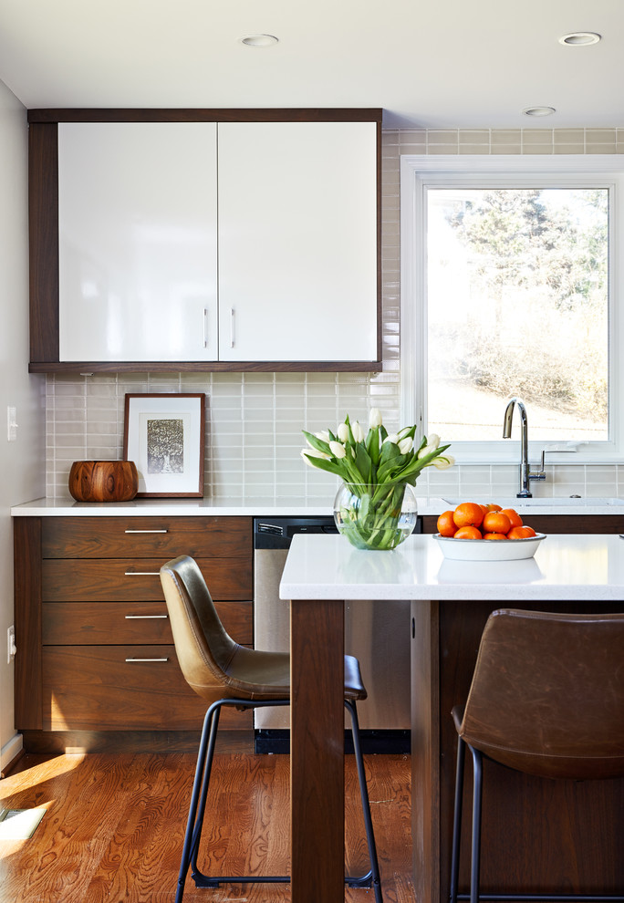 Ejemplo de cocinas en L contemporánea de tamaño medio abierta con fregadero bajoencimera, armarios con paneles lisos, puertas de armario de madera oscura, encimera de cuarzo compacto, salpicadero beige, salpicadero de azulejos de cerámica, electrodomésticos de acero inoxidable, suelo de madera en tonos medios, una isla y suelo marrón