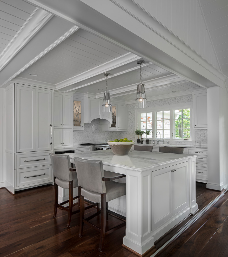 Inspiration for a large transitional l-shaped dark wood floor open concept kitchen remodel in Detroit with a double-bowl sink, recessed-panel cabinets, white cabinets, marble countertops, white backsplash, paneled appliances and an island