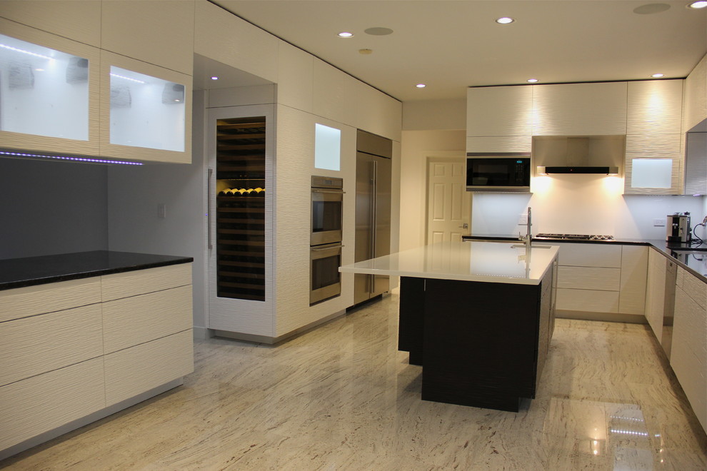 Inspiration for a medium sized contemporary l-shaped kitchen/diner in Chicago with flat-panel cabinets, white cabinets, composite countertops, white splashback, glass sheet splashback, stainless steel appliances, laminate floors and an island.