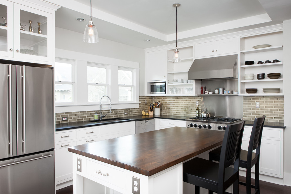 Trendy kitchen photo in Portland with open cabinets, stainless steel appliances, wood countertops, white cabinets, brown backsplash and subway tile backsplash