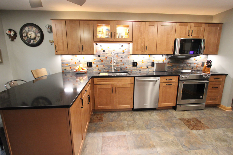 Exempel på ett mellanstort klassiskt svart svart kök, med en undermonterad diskho, luckor med infälld panel, skåp i mellenmörkt trä, bänkskiva i kvarts, flerfärgad stänkskydd, stänkskydd i mosaik, rostfria vitvaror, vinylgolv och flerfärgat golv