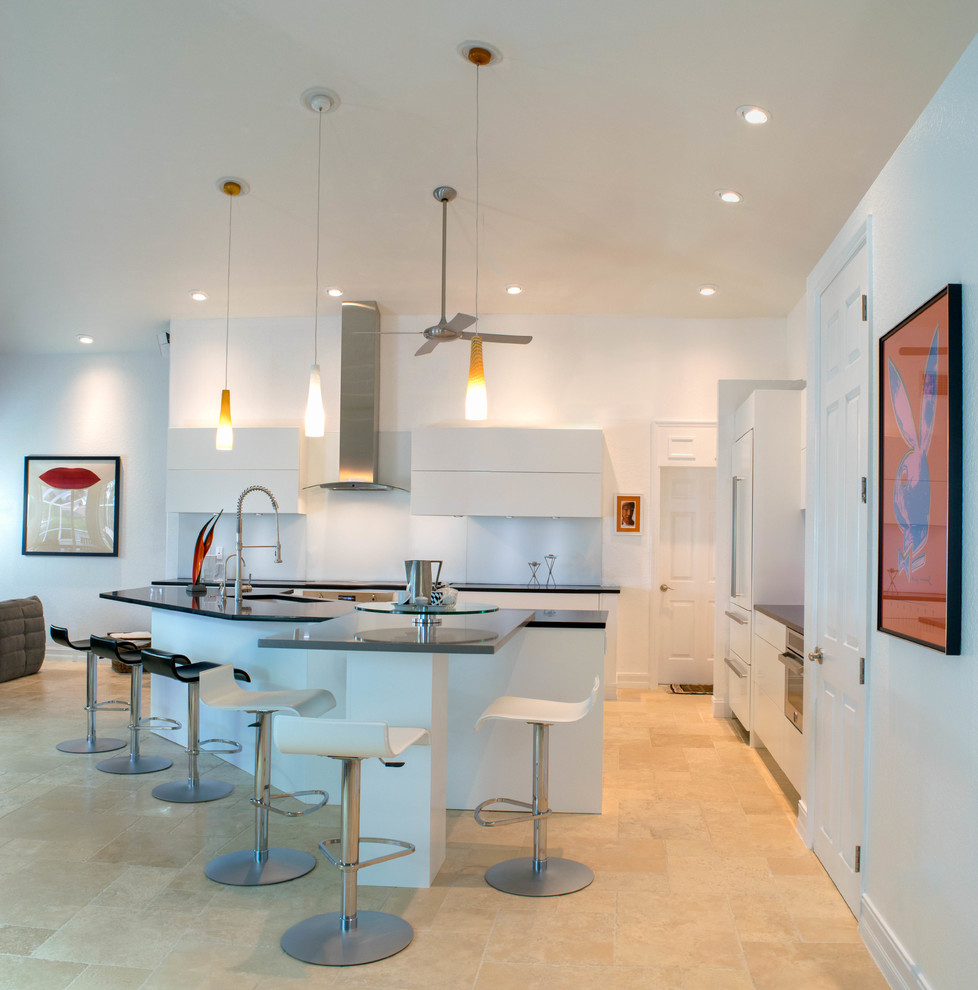 Exempel på ett mellanstort modernt kök, med släta luckor, vita skåp, vitt stänkskydd, glaspanel som stänkskydd, en köksö, en undermonterad diskho, rostfria vitvaror, klinkergolv i keramik, bänkskiva i kvartsit och beiget golv