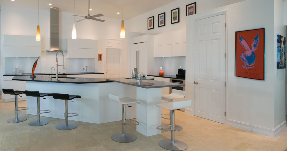 Medium sized contemporary l-shaped open plan kitchen in Miami with a submerged sink, flat-panel cabinets, white cabinets, stainless steel appliances, ceramic flooring, an island, beige floors and quartz worktops.