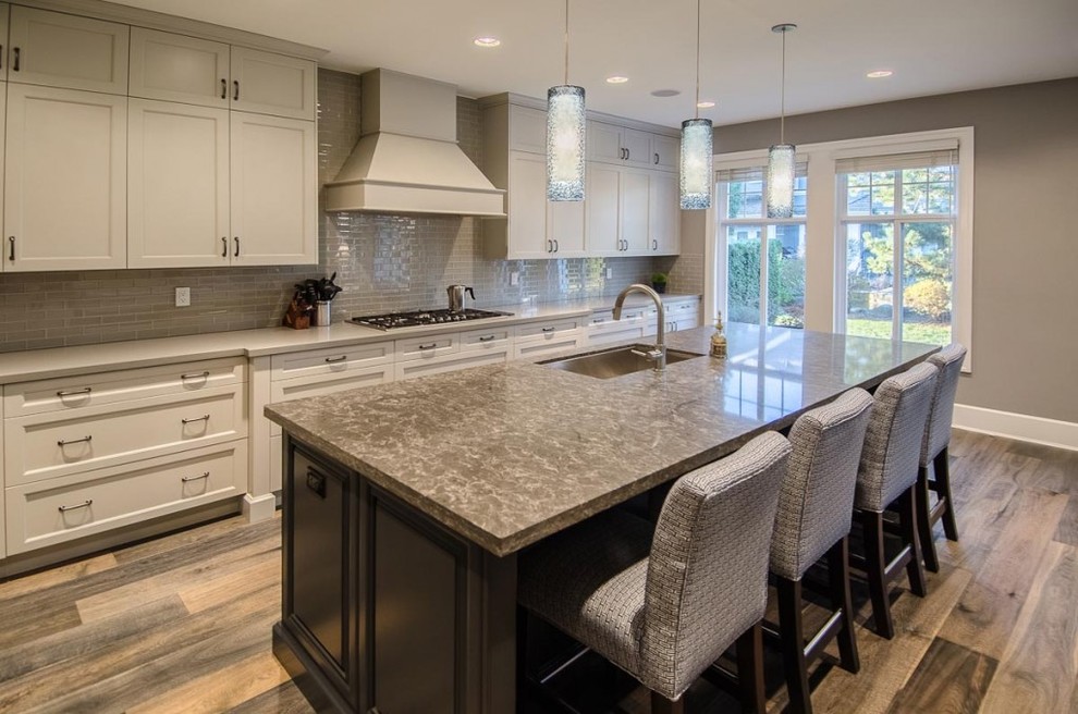 Eat-in kitchen - large contemporary l-shaped vinyl floor eat-in kitchen idea in Vancouver with an undermount sink, shaker cabinets, white cabinets, gray backsplash, subway tile backsplash, stainless steel appliances and an island