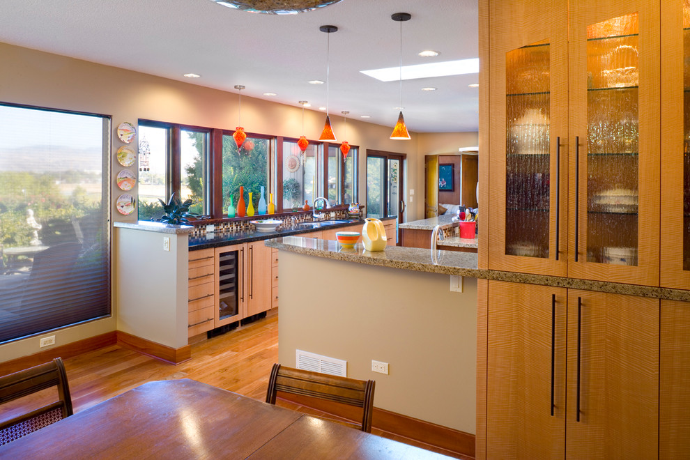 Eat-in kitchen - large eclectic u-shaped light wood floor eat-in kitchen idea in Boise with an undermount sink, flat-panel cabinets, light wood cabinets, granite countertops, multicolored backsplash, ceramic backsplash, stainless steel appliances and an island