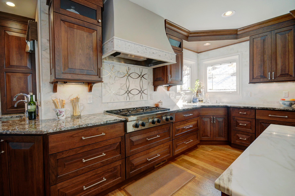 Medium sized classic u-shaped enclosed kitchen in Denver with raised-panel cabinets, dark wood cabinets, marble worktops, beige splashback and medium hardwood flooring.