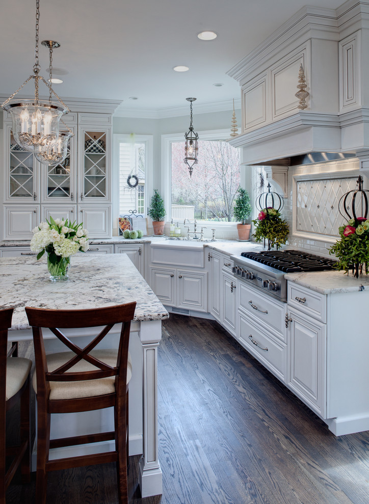 Kitchen - traditional kitchen idea in Chicago with a farmhouse sink, raised-panel cabinets, white cabinets and white countertops