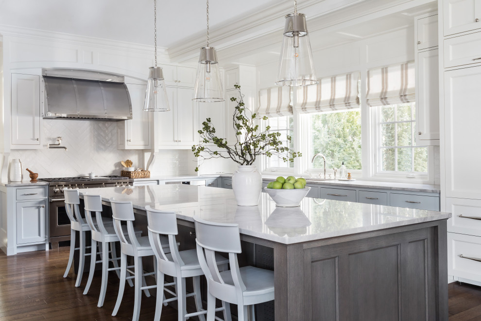 Inspiration for a large timeless l-shaped medium tone wood floor and brown floor kitchen remodel in Boston with an undermount sink, shaker cabinets, blue cabinets, white backsplash, stainless steel appliances, an island and gray countertops